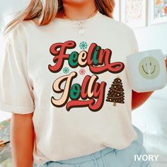 Feeling Jolly Shirt, Christmas Shirt, Comfort Colors, Christmas Family Shirt, Merry Christmas Gift Shirt,jolly Christmas  Party Shirt,192143 COMFORT COLORS - ADULT UNISEX - SHORT SLEEVE T-SHIRT - 1717 6.1 oz./yd² (US), 10 oz/L yd (CA), 100% ring-spun cotton, 30 singles Garment dyed for that lived in feel and almost no shrinkage at home. Soft ring-spun cotton fabric with 100% cotton threads Relaxed fit Topstitched, classic width, rib collar Shoulder to shoulder twill tape Signature twill label Ma Christmas Party Shirt, Christmas Family Shirt, Merry Christmas Gift, Christmas Party Shirts, Merry Christmas Gifts, Sustainable Manufacturing, Merry Christmas Shirts, Jolly Christmas, Comfort Colors Shirt