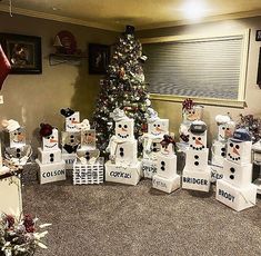 there are many boxes that have snowmen on them in front of a christmas tree