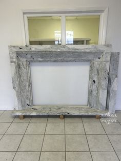 an old window frame sitting on the floor in front of a tiled flooring area