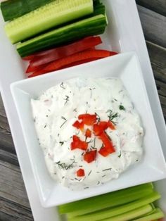 a white plate topped with cucumber, carrots and celery