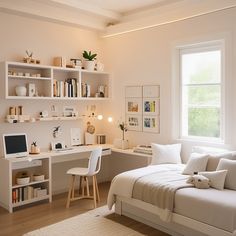 a bedroom with a bed, desk and computer