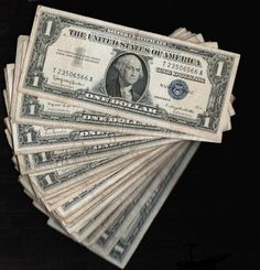 twenty dollar bills are stacked on top of each other in front of a black background