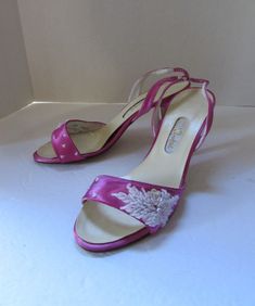 "SALE! 15% OFF! Elegant evening high heel shoes in lovely peony pink satin.  They are labeled as a Dyeable brand--this would be shoes specifically purchased to dye to a requested color to match a total look outfit (see purse at 93262b). The shoes are open toe and sling back.  The toe strap area is decorated with white seed beads and sequins in a floral spray.  The sling back has slight elastic give wrapped in silver threads. They are labeled as Made in America Size: Label says size 7.0  -- 9\" o Bermuda Bags, Event Shoes, Peony Pink, Sequin Decor, Floral Spray, Size Label, Sling Back, White Beads, Pink Satin