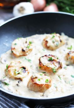 shrimp and grits in a creamy sauce with onions on the side, ready to be eaten