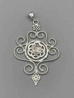 I've designed this Victorian Steampunk with a Celtic infusion infusion necklace entirely in sterling silver featuring a center cabochon gemstone of your choosing in the drop down menu. It is abstract, Celtic, and classic in one piece! The frame, or centering, of the pendant is made with Eternity circles with a Celtic Trinity Knot at the bottom. It comes with a sterling box chain of your length preference in the drop down menu. Please allow at least business days for me to fabricate your order. D Silver Cabochon Medallion Jewelry, Ornate Silver Cabochon Necklace, Ornate Silver Necklace With Cabochon, Artisan Silver Jewelry With Cabochon, Eclectic Necklace, Celtic Trinity Knot, Trinity Knot, Steampunk Necklace, Victorian Steampunk