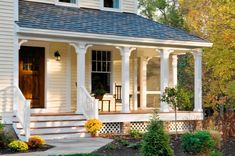 a white house with porch and steps leading to the front door