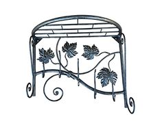 a wrought iron shelf with leaves on it