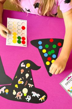 Two decorated sticker witch hats with colorful dot stickers, highlighting a simple and fun Halloween activity for preschoolers. Halloween Witch Crafts Preschool, Hat Activity For Preschool, Triangle Halloween Crafts Preschool, Halloween Activity For Preschool, Halloween Table Activities For Preschool, Witch Craft For Preschoolers, Witch Crafts Preschool, Halloween Crafts For Preschoolers Easy, Witch Preschool Craft