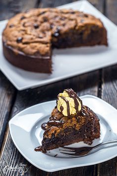 a piece of chocolate cake on a white plate with a fork next to the slice