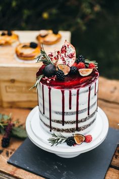 a cake with fruit on top sitting on a table