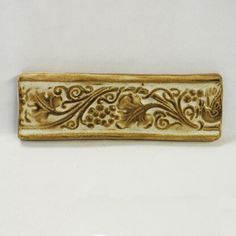 an ornately decorated rectangular object on a white background