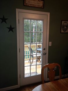 an open door leading to a patio with stars on the wall and table in front of it