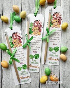 three bookmarks with green ribbons on top of them and lemons around the edges