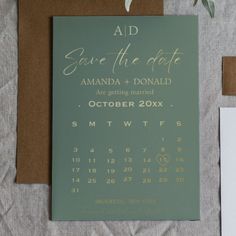 wedding stationery and save the date cards are displayed on top of a piece of brown paper