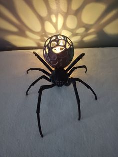 a spider lamp sitting on top of a white surface