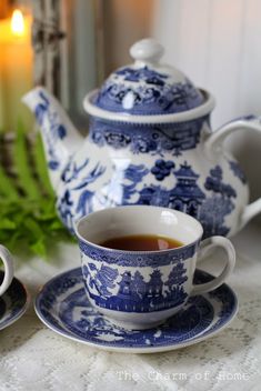 a blue and white tea set on a table