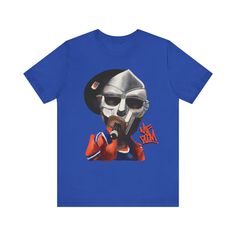 Elevate your style with our exclusive MF Doom shirt. Crafted for true hip hop fans, this tee merges comfort with swag. Embrace the vibes of this rap legends and make a statement wherever you go. This classic unisex jersey short sleeve tee fits like a well-loved favorite. Soft cotton and quality print make users fall in love with it over and over again. These t-shirts have-ribbed knit collars to bolster shaping. The shoulders have taping for better fit over time. Dual side seams hold the garment's shape for longer.  .: 100% Airlume combed and ringspun cotton (fiber content may vary for different colors) .: Light fabric (4.2 oz/yd² (142 g/m .: Retail fit .: Tear away label .: Runs true to size Hip Hop Cotton T-shirt For Streetwear, Hip Hop Style Screen Print Shirt For Streetwear, Hip Hop Streetwear Shirt With Screen Print, Hip Hop Style Shirt With Screen Print For Streetwear, Pop Culture Streetwear Shirt With Letter Print, Hip Hop Cotton Tops For Streetwear, Cotton Hip Hop Tops For Streetwear, Hip Hop Graphic Shirt For Streetwear, Pop Culture T-shirt With Sublimation Print For Streetwear