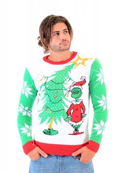 a man wearing an ugly christmas sweater standing in front of a white background