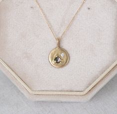 The stunning Abigail necklace features a 3mm chocolate diamond with a smaller, 2mm white diamond in a flush setting in solid gold. The offset stones combined with the variety of settings makes her unique, yet ever so gorgeous. Abigail is about 12mm across, in total. A true beauty!  Paired with your choice of a 16inch chain or an 18inch chain solid gold chain.   Handmade in my studio.