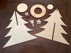 wooden christmas trees cut out and placed on a table with other woodworking supplies to make them look like they have been made from plywood