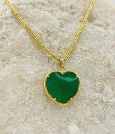 Indulge in the luxurious beauty of our Green Love Stone Necklace. Handcrafted in Jaipur, India, this stunning necklace features a heart-shaped green chalcedony, a semi-precious gemstone known for its calming and healing properties. Elevate your style and energy with this exclusive piece. Chalcedony is a Birthstone of may Luxury Green Heart Pendant Jewelry, Emerald Heart Shaped Gemstone Necklace, Green Heart-shaped Fine Jewelry Necklace, Luxury Green Heart-shaped Necklaces, Green Heart-shaped Gemstone Necklace, Green Love, Green Chalcedony, Jaipur India, Green Necklace