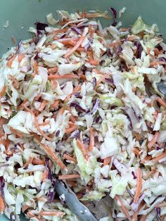 a bowl filled with coleslaw and carrots