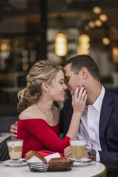 a man and woman sitting next to each other at a table