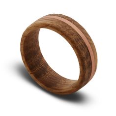 a wooden ring with two pink stripes on it