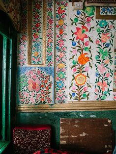 the wall is covered with colorful flowers and leaves