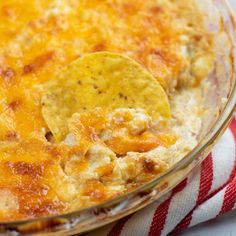 a casserole dish with tortilla chips in it on a red and white towel