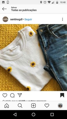 two t - shirts with sunflowers on them sitting next to each other