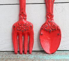 two red plastic utensils sitting next to each other