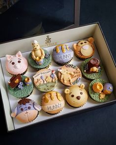 twelve cupcakes in a box with winnie the pooh and friends on them