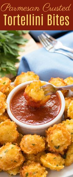 a white plate topped with tater tots covered in tomato sauce