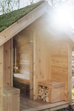 a wooden sauna with grass on the roof