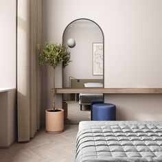 a bedroom with a bed, plant and mirror