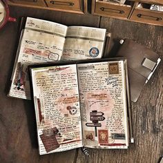 an open book sitting on top of a wooden table next to a clock and other items