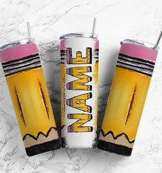 two yellow and pink tumblers sitting on top of a white marble counter next to each other