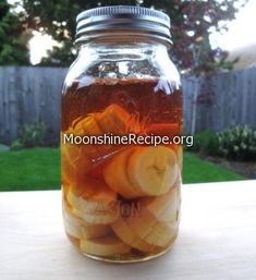 a mason jar filled with sliced bananas and apple slices