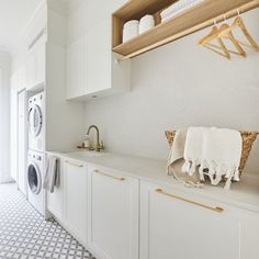 a washer and dryer in a white laundry room