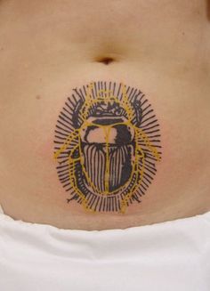 a woman's stomach with a scarp tattoo on it