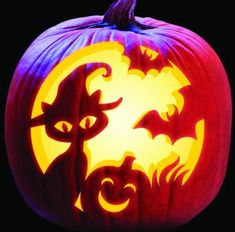 a carved pumpkin with cats and bats on it