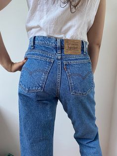 Vintage 550 Levi's jeans. Dark Wash denim, really great 550 type. Zipper fly. High waisted. Made in 90s. Tapered leg. Orange tab. Size: W29 L30. Please check the measurements. Measurements taken with item laying flat on the ground. Waist: 36,5cm, 14,3" HIGH WAIST! Rise: 28cm, 11" Hip: 53cm, 20,8" Inseam: 75cm, 29,5" Knee: 24cm, 9,4" Leg opening: 16cm, 6,2" Material:100% cotton, thick denim. Perfect condition, no stains or holes. 10/10! Will come fresh, ready to be worn right away! This item will Vintage Jeans Aesthetic, 550 Levis Jeans, 80s Jeans, 90s Levis, Levis 550 Jeans, 90s Jeans, Jean Vintage, Jeans Dark Wash, Womens Jeans