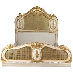 an ornate gold and white bed frame