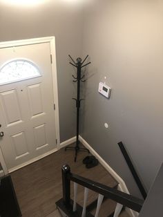 an entry way with a door and some stairs