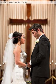 a bride and groom standing in front of the alter during their wedding ceremony at st luke's church