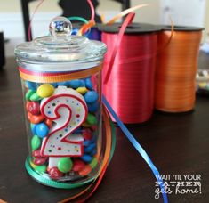 there is a jar filled with candy and the number two on it's lid