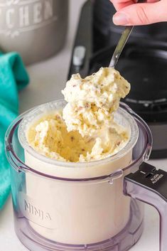 someone is scooping mashed potatoes out of an electric pressure cooker with a spoon