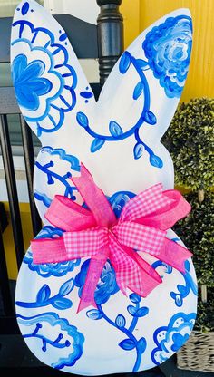 an easter bunny painted with blue and pink flowers