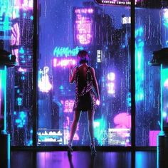 a woman standing in front of a window with neon lights on the windowsills